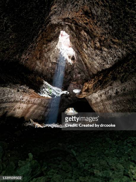sun comes into the lava tube known as cueva de las palomas - la palma islas canarias fotografías e imágenes de stock