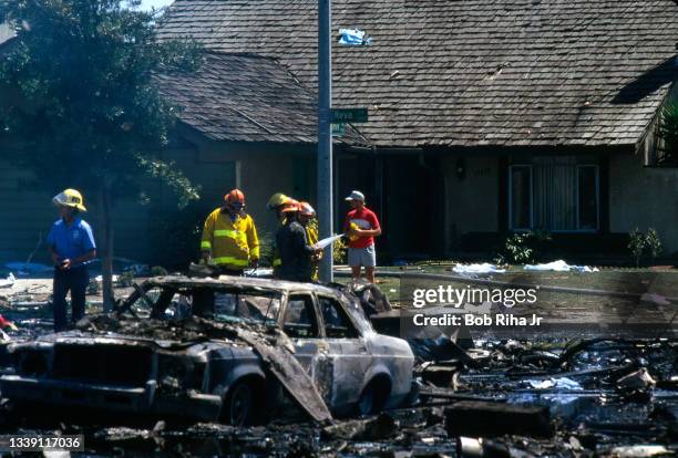 Los Angeles County firefighters and mutual aid agencies work within the debris field after a mid-air collision with Aeromexico Flight 498 and Piper...