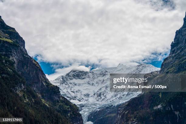 scenic view of snowcapped mountains against sky,switzerland - desire stock-fotos und bilder