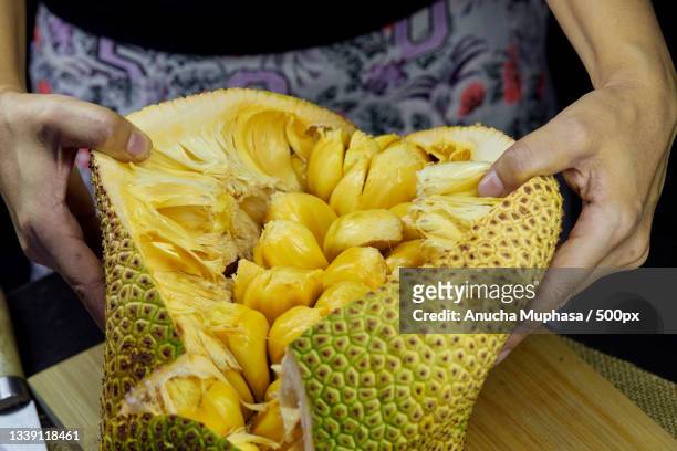 midsection of woman preparing food,bangkok,thailand - jackfruit stock-fotos und bilder