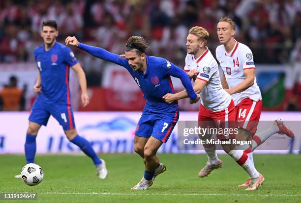 Jack Grealish of England is tackled by Kamil Jozwiak of Poland during the 2022 FIFA World Cup Qualifier match between Poland and England at Stadion...
