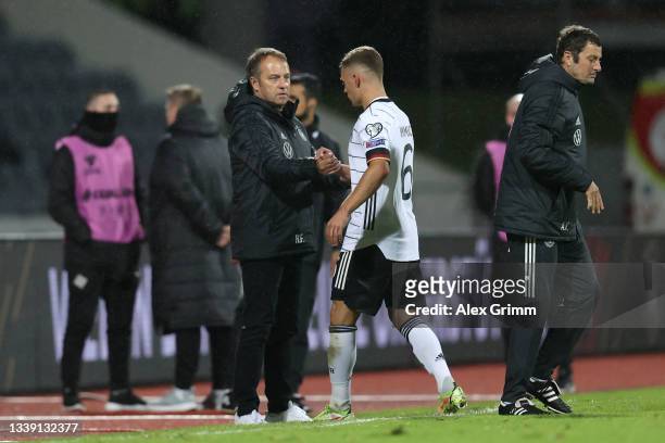 Hans-Dieter Flick, Head Coach of Germany congratulates Joshua Kimmich of Germany after the 2022 FIFA World Cup Qualifier match between Iceland and...