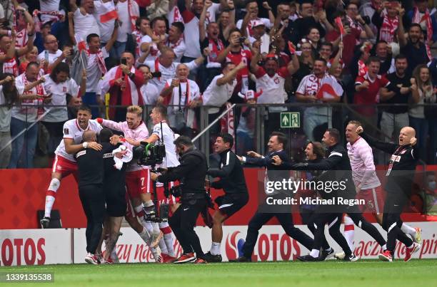 Jan Bednarek and Kamil Jozwiak of Poland celebrate the goal of team mate damian Szymanski during the 2022 FIFA World Cup Qualifier match between...