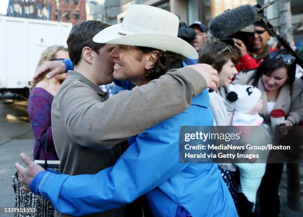 Jeff Bauman, who lost both legs in the Boston Marathon bombing, is greeted by Carlos Arredondo, who helped save his life, as Bauman arrives at the...