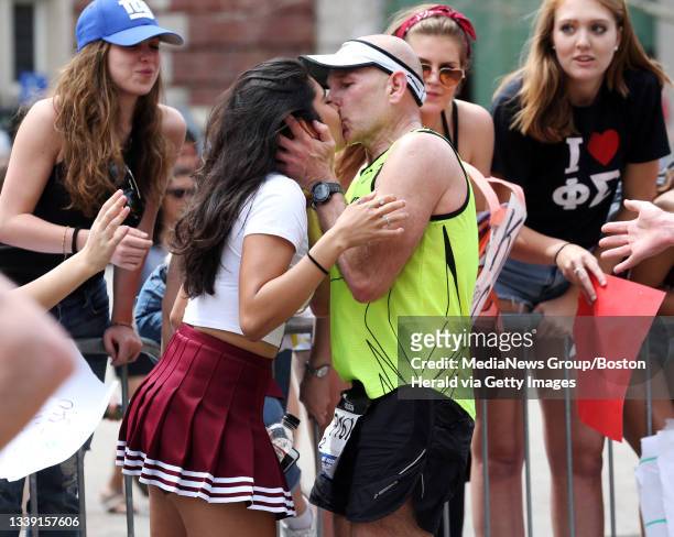 Sorority girl gets a kiss from a runner outside Wellesley College during the 121st Boston Marathon, Monday, April 17, 2017. Staff photo by Angela...