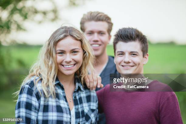 three caucasian teenagers smiling at the camera - girl 18 stock pictures, royalty-free photos & images
