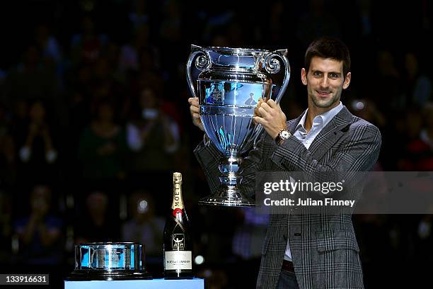 Novak Djokovic of Serbia poses with the end of season number one trophy during the Barclays ATP World Tour Finals at the O2 Arena on November 22,...