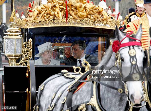 Queen Elizabeth II and Dr Abdullah Gul the President of the Republic of Turkey arrive in the Royal Carriage as they arrive at Buckingham Palace on...