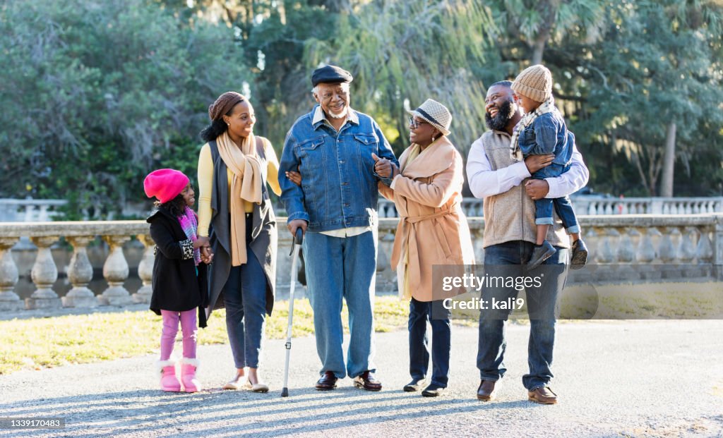 Three generation African-American family walking in park