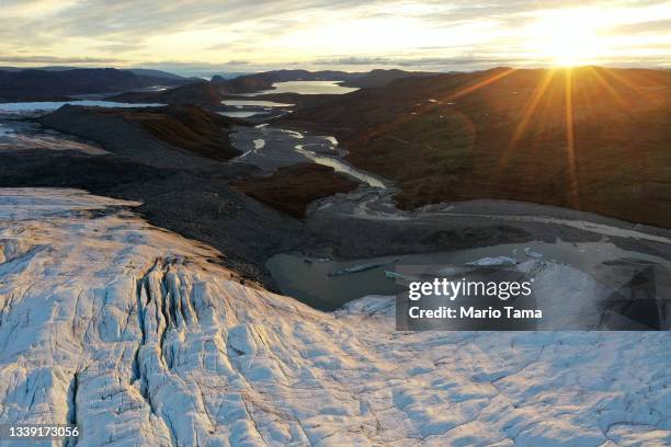 In an aerial view, meltwater flows away from the retreating Reindeer Glacier on September 08, 2021 near Kangerlussuaq, Greenland. 2021 will mark one...