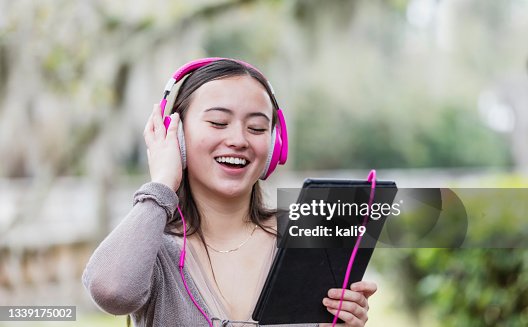 Multiracial teenage girl, headphones and digital tablet Multiracial teenage girl, headphones and digital tablet