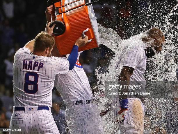 Jason Heyward of the Chicago Cubs gets dunked with ice water by Ian Happ and Patrick Wisdom after hitting a walk-off, three run home run in the 10th...