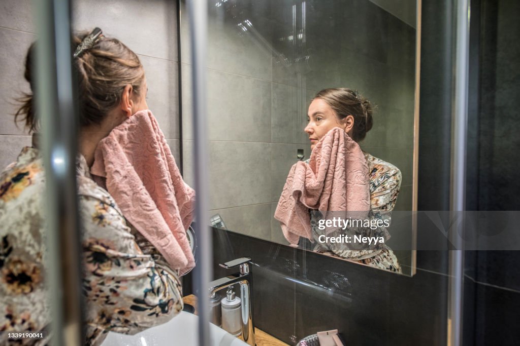 Bathrobe Routine Woman In Silky Bathrobe During Evening Routine In The Bathroom High-Res ...