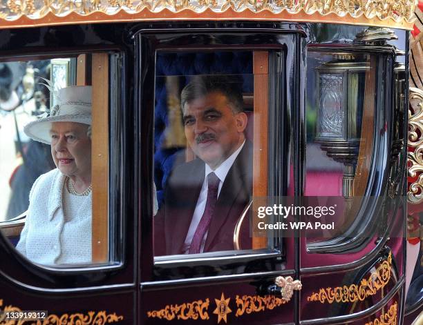 Queen Elizabeth II and Dr Abdullah Gul the President of the Republic of Turkey arrive in the Royal Carriage as they arrive at Buckingham Palace on...