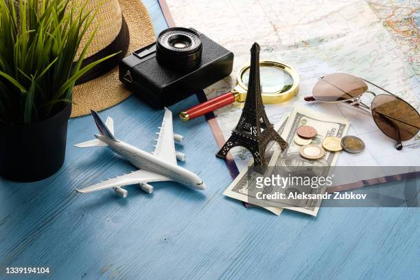 items for summer holidays: camera, sunglasses, cash, straw hat, mobile phone, map and travel plan. tourist layout-set and accessories of the traveler, on a wooden background. open borders concept for free happy travel. a copy of the text space. - holiday border stock pictures, royalty-free photos & images