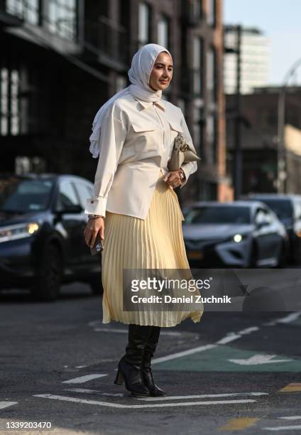 Guest is seen wearing a cream jacket and yellow skirt outside the Peter Do show during New York Fashion Week S/S 22 on September 08, 2021 in New York...