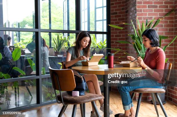 diverse group of asian business coworkers having take away food meal at office cafeteria during lunch break - office recycling stock pictures, royalty-free photos & images