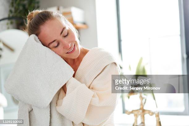 woman wiping face in bathroom - woman with towel spa stock pictures, royalty-free photos & images