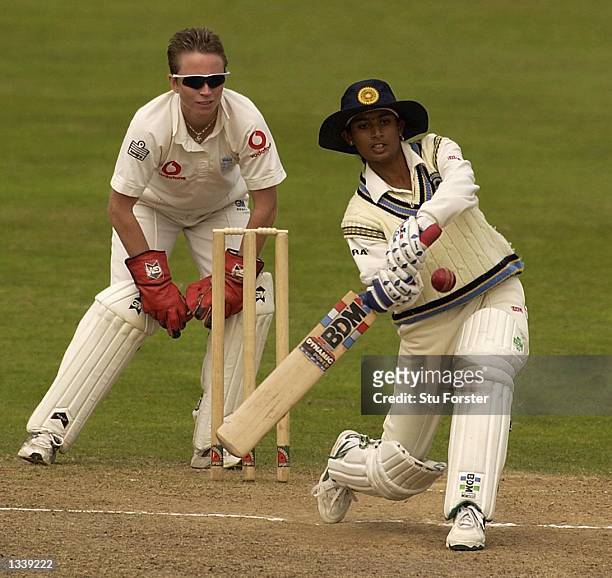 Mithali Raj of India hits out watched by England wicketkeeper Mandie Godliman during the Second Day of the Second Test Match between England and...