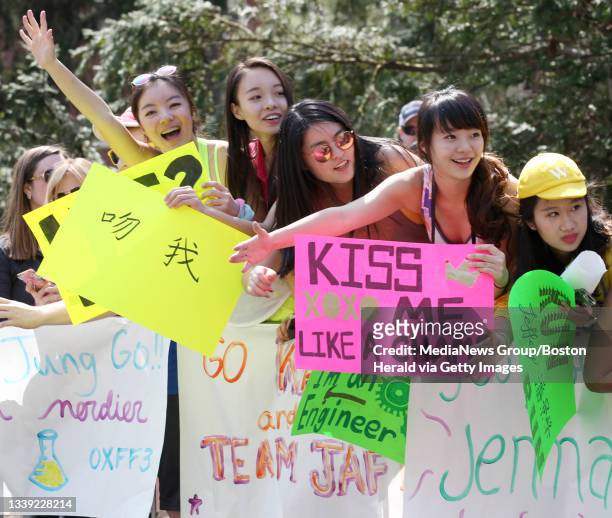 Wellesley College students Amy Jin, left, Coco Xiao, Michelle Wu, Sophie Li, and Joyce Wang cheer on runners during the 120th Boston Marathon,...