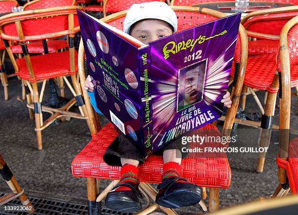 Nepalese Guinness World Record holder Khagendra Thapa Magar the second world's smallest man with 67 cm , poses with the 2012 Ripley book of World...