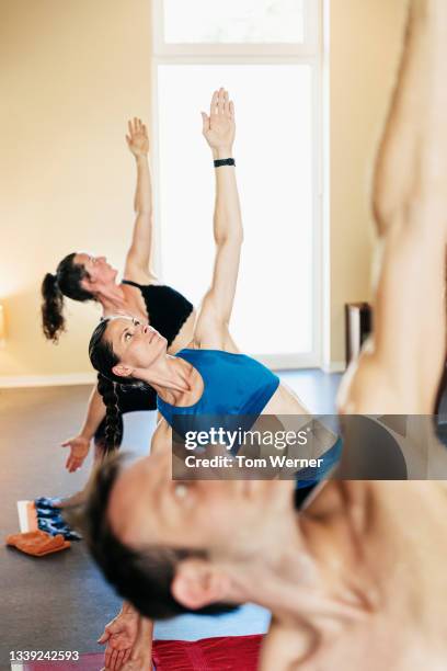 people posing and sweating in hot yoga class - bikram yoga stock-fotos und bilder