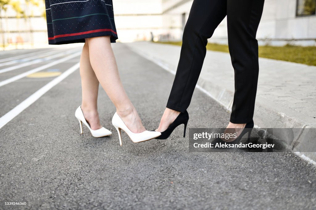 Elegant Females Using Feet And High Heels To Greet Each Other During COVID-19 Pandemic