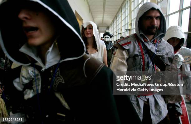 Boston, MA - Attendants dressed as characters from the video game Assasins Creed 2 march down a hallway during Anime Boston 2011 at the Hynes...
