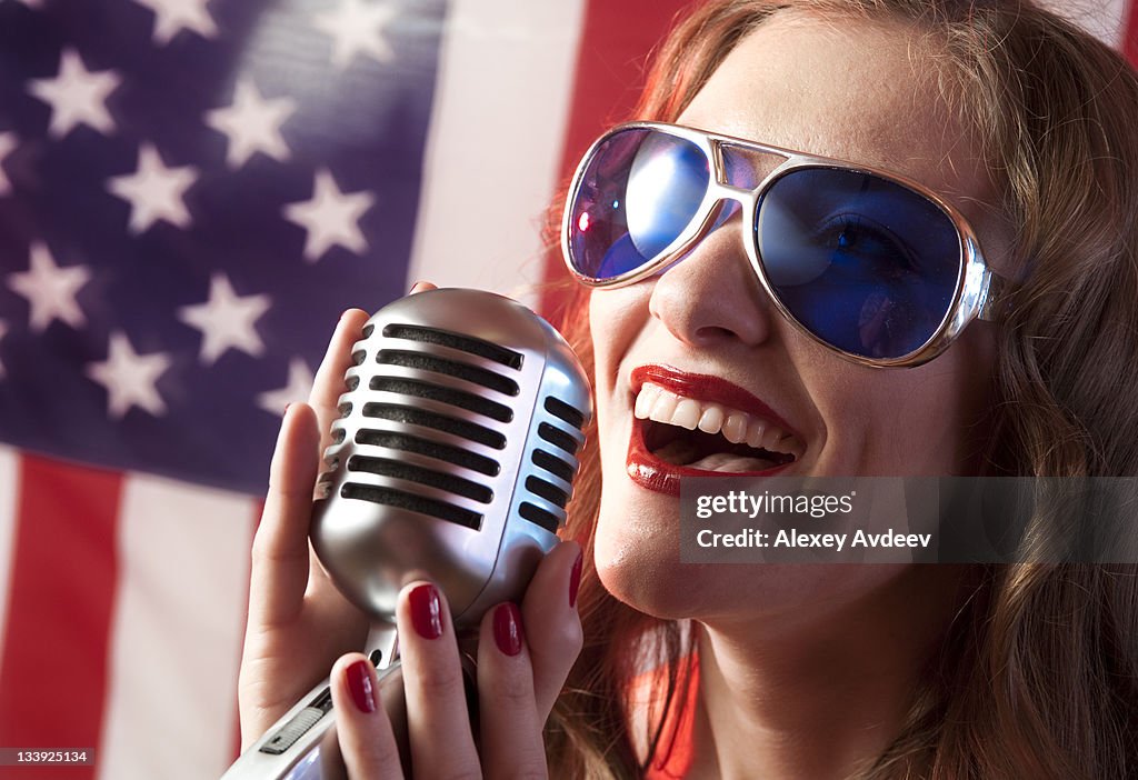Woman Singing into Microphone