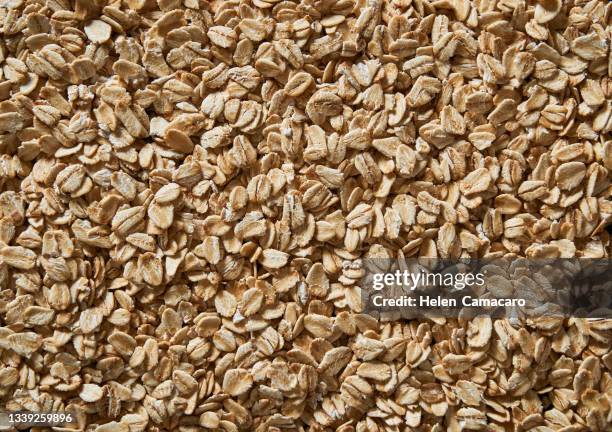 oat flakes background - cereales stock pictures, royalty-free photos & images