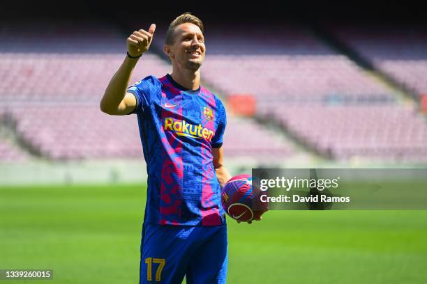 Luuk de Jong reacts whilst posing for a photograph as he is presented as a Barcelona player at Camp Nou Stadium at Camp Nou on September 09, 2021 in...