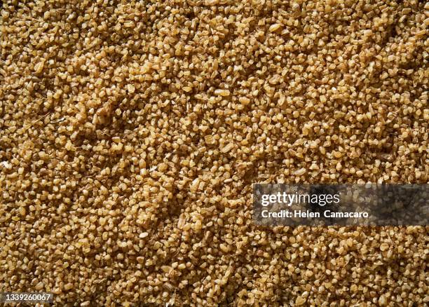 top view of uncooked wheat grain background - cereales stock pictures, royalty-free photos & images
