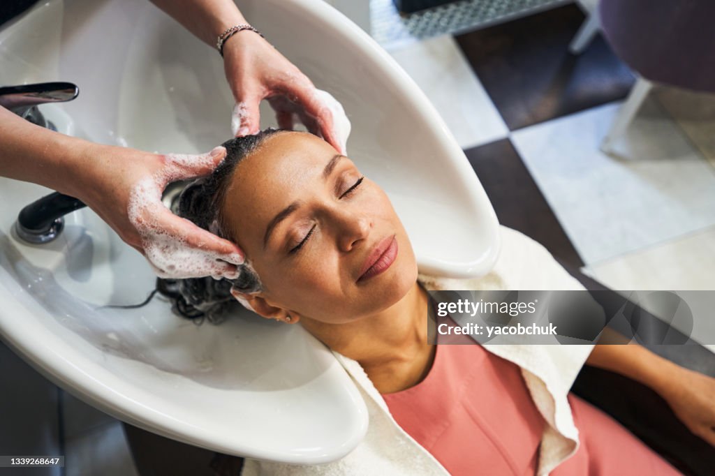 Top view of client sitting close to sink