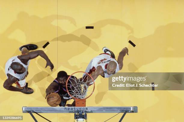 Robert Traylor, Center for the Cleveland Cavaliers drives to the basketball as Bruce Bowen, Small Forward for the Miami Heat reaches out to block...