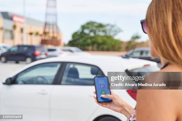 closed plan of an authorized contactless payment made with a smartphone in a parking area. - park service stock pictures, royalty-free photos & images