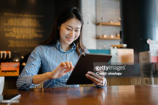 asian business girl working in cafe - girl in office stock pictures, royalty-free photos & images