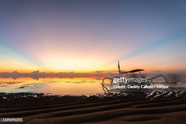 scenic view of sea against sky during sunset,sanur,indonesia - sanur stock pictures, royalty-free photos & images