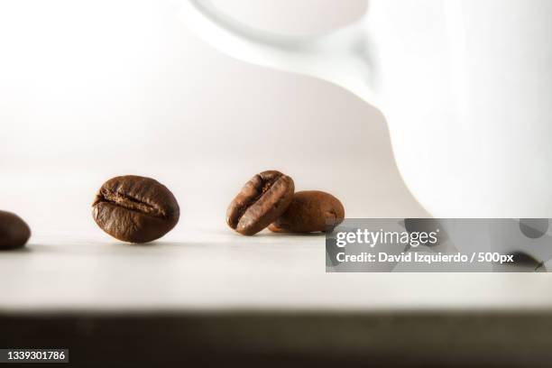 close-up of coffee beans on table - broken coffee maker stock pictures, royalty-free photos & images