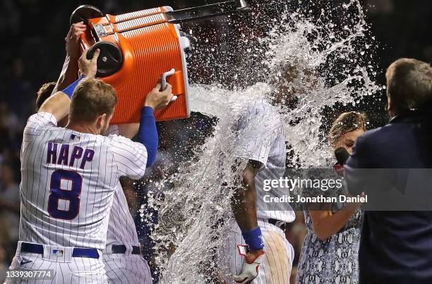 Jason Heyward of the Chicago Cubs gets dunked with ice water by Ian Happ and Patrick Wisdom after hitting a walk-off, three run home run in the 10th...