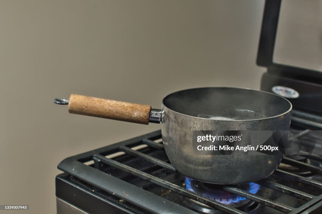 Close-up of cooking pan on stove in kitchen