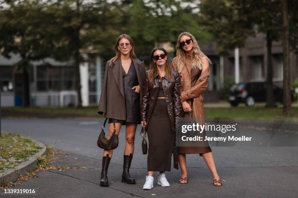 Maike wearing a brown Jacket, a brown leather dress, a prada mini bag and brown boots, Sonja wearing a brown leather jacket, a brown skirt, a louis...