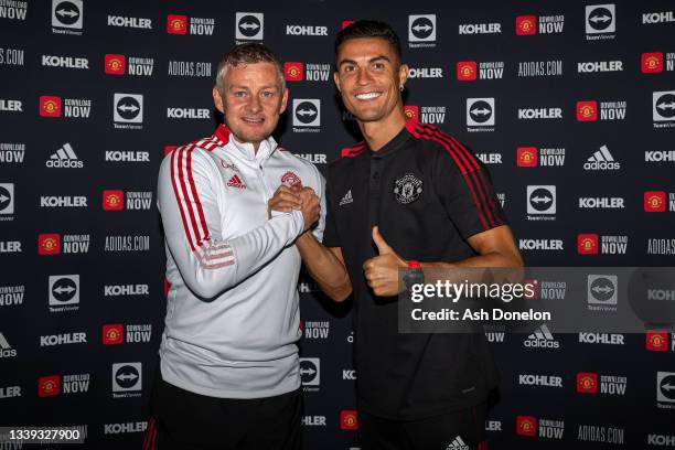 Cristiano Ronaldo of Manchester United poses with Manager Ole Gunnar Solskjaer after signing his contract with the club at Carrington Training Ground...