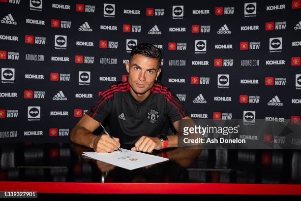 Cristiano Ronaldo of Manchester United poses after signing his contract with the club at Carrington Training Ground on September 08, 2021 in...