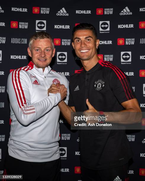 Cristiano Ronaldo of Manchester United poses with Manager Ole Gunnar Solskjaer after signing his contract with the club at Carrington Training Ground...
