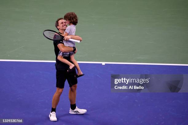 Bruno Soares of Brazil celebrates with his son Noah after he and Jamie Murray of Great Britain defeated Filip Polasek of Slovakia and John Peers of...