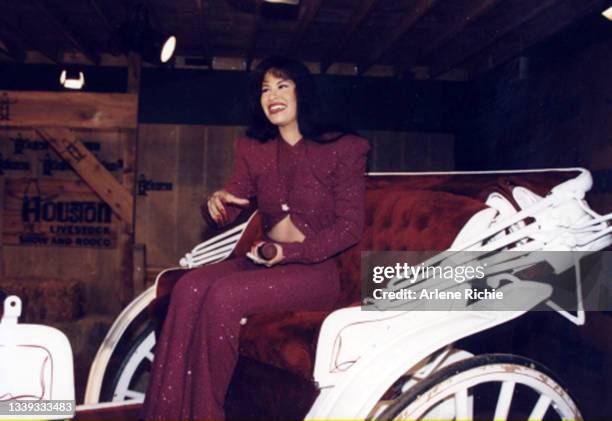 American singer Selena rides in a carriage during a performance at the Houston Livestock Show & Rodeo at the Houston Astrodome, Houston, Texas,...