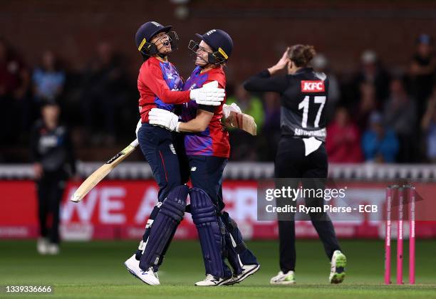 Sophia Dunkley and Katherine Brunt of England celebrate after hitting the winning runs during the 3rd Womens International T20 between England and...