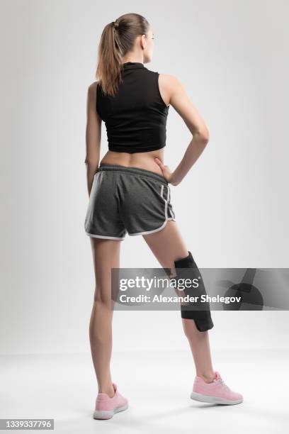 studio portrait of young sports woman with reusable post-injury ice-pack with liquid gel. rehabilitation and recovery concept - strap stock pictures, royalty-free photos & images
