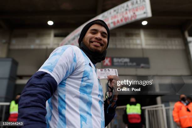 Fan shows his ticket as he arrives to the stadium before a match between Argentina and Bolivia as part of South American Qualifiers for Qatar 2022 at...