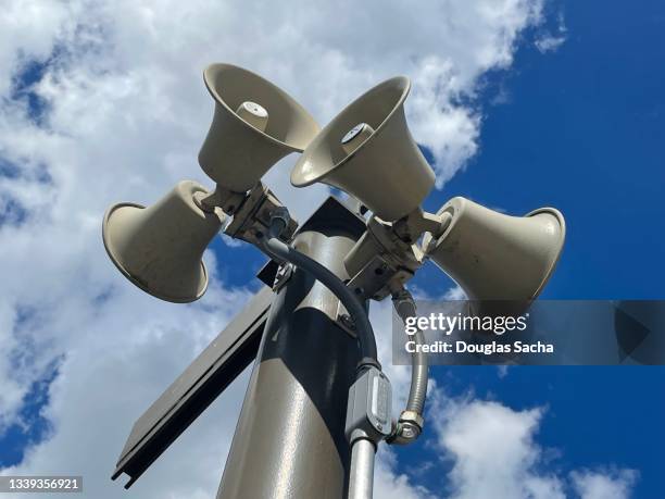 warning sirens on a pole - sirene stockfoto's en -beelden